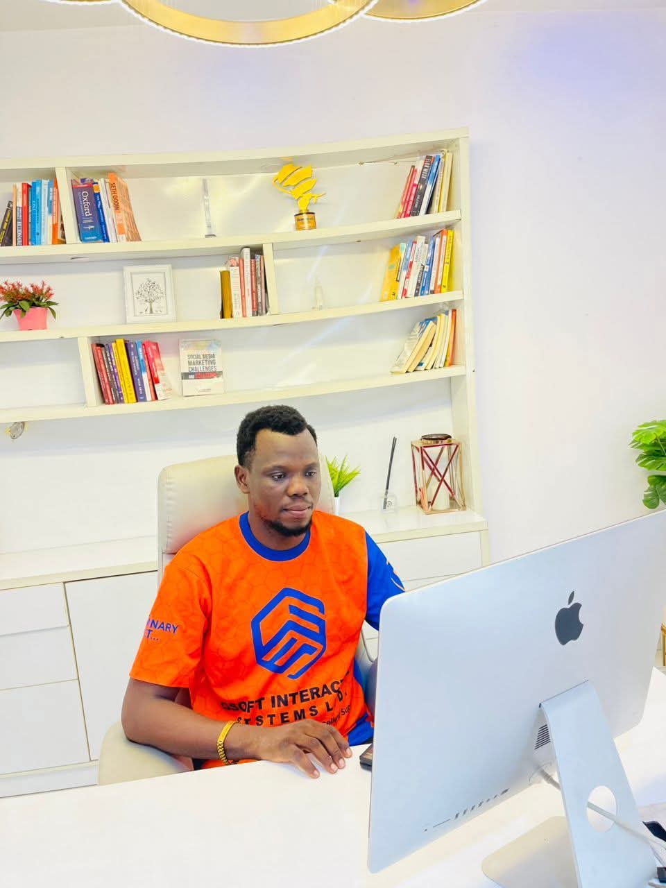 Mr. Gift Edegware working at his iMac in the Gsoft Interactive Systems office, Lagos, Nigeria